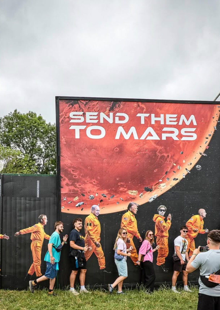The mural by Led By Donkeys at Glastonbury, featuring likenesses of Trump, Musk and Putin