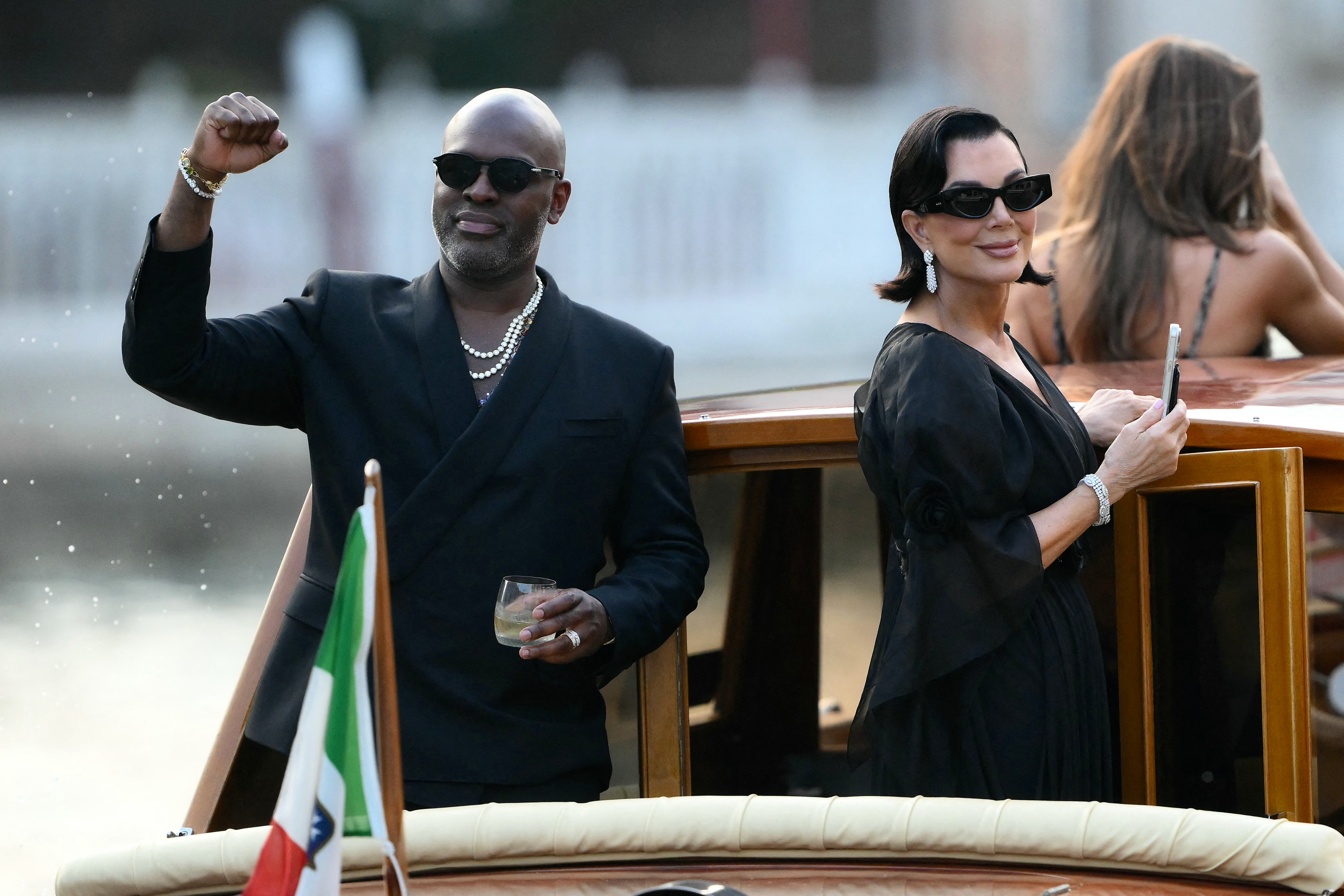 The ‘momager’ was seen smiling on the boat with her longtime partner Corey Gamble, who wore an all black suit and silver chains