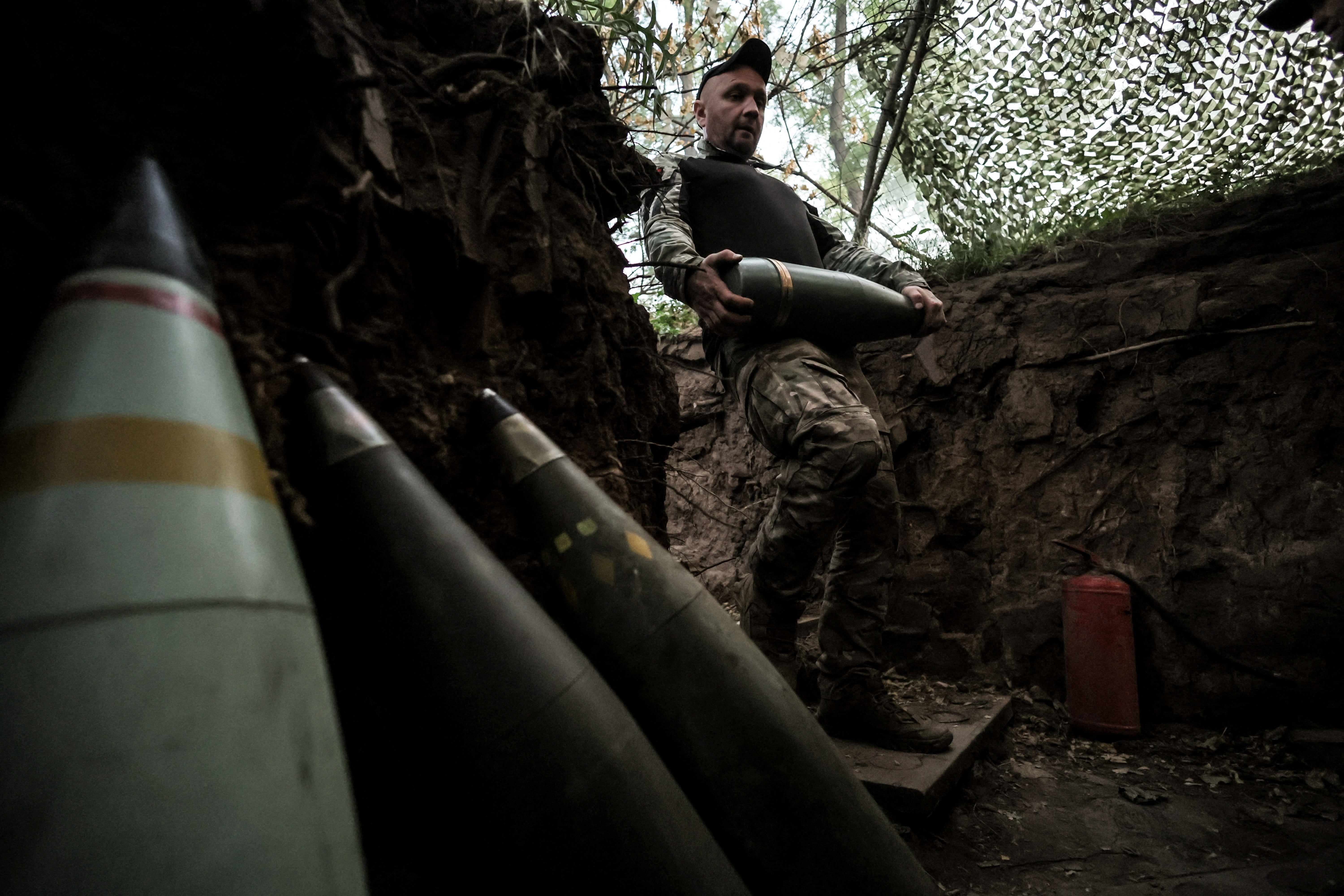 A Ukrainian troop prepares to fire a M109 self-propelled howitzer