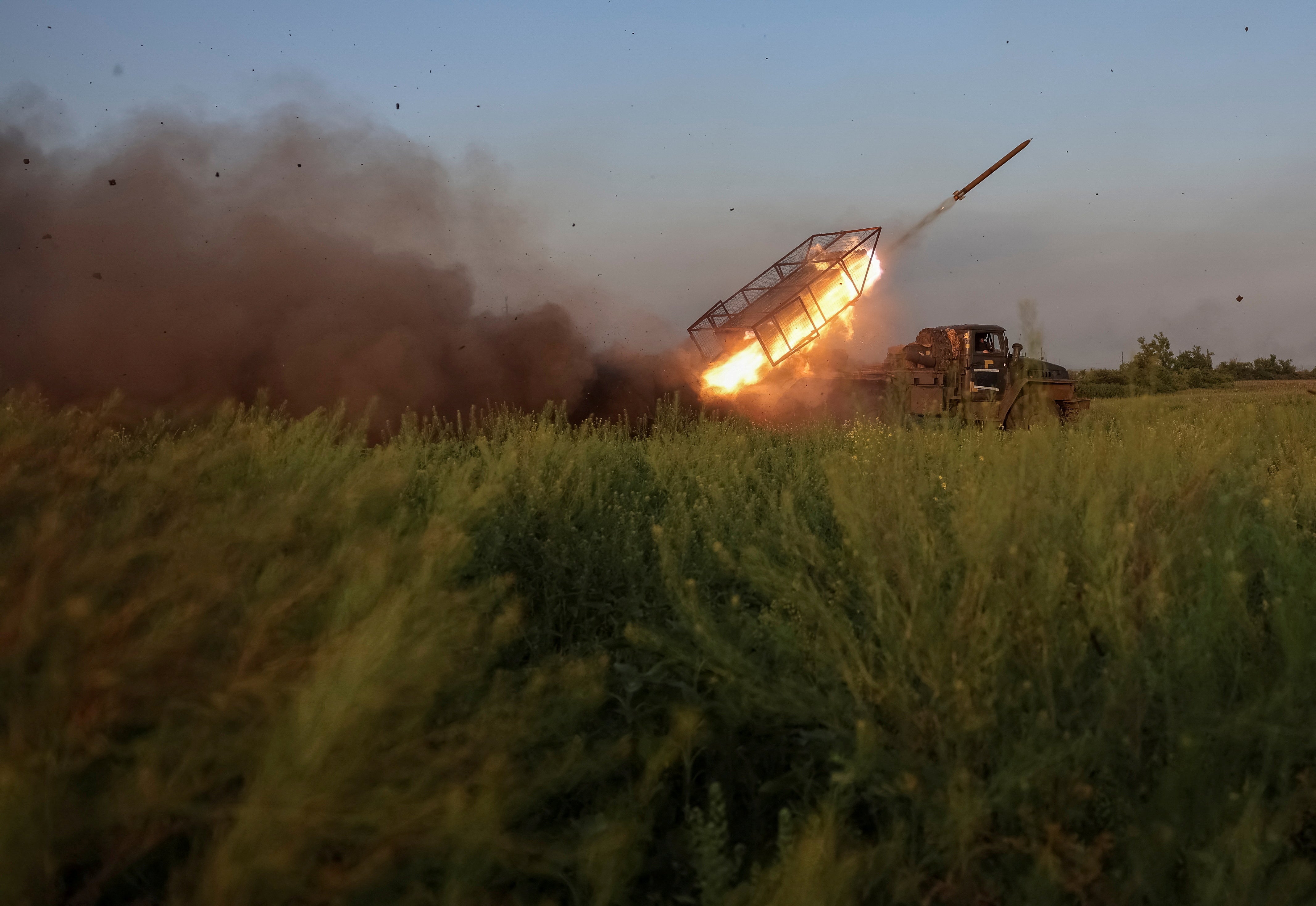 Servicemen of the 25th Separate Airborne Brigade of the Armed Forces of Ukraine fire a BM-21 Grad multiple rocket launch system towards Russian troops