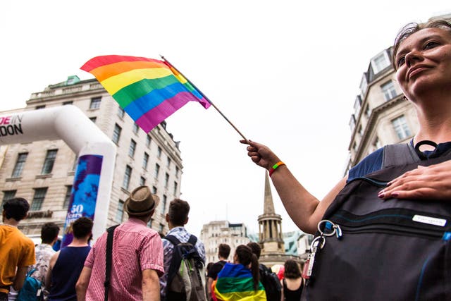 <p>Pride campaigners march through central London</p>