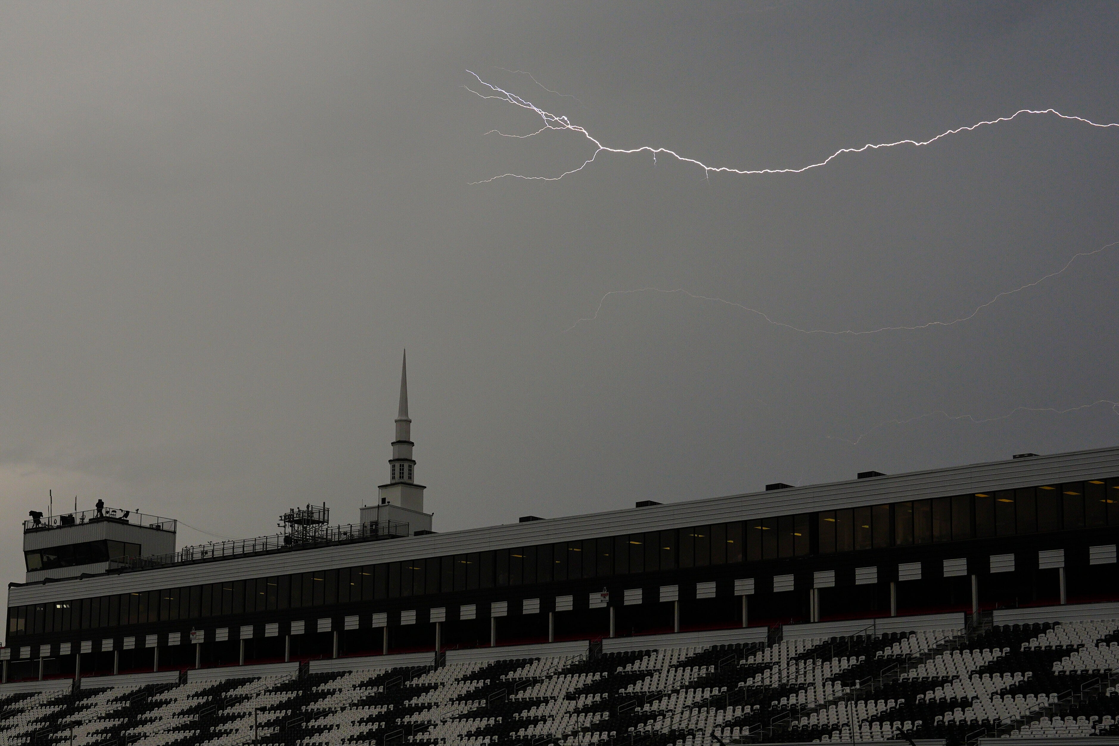There is no safe place outside when thunderstorms that can produce lightnings like it are in the region. Head inside and stay inside for 30 minutes after the last rumble of thunder or a flash.