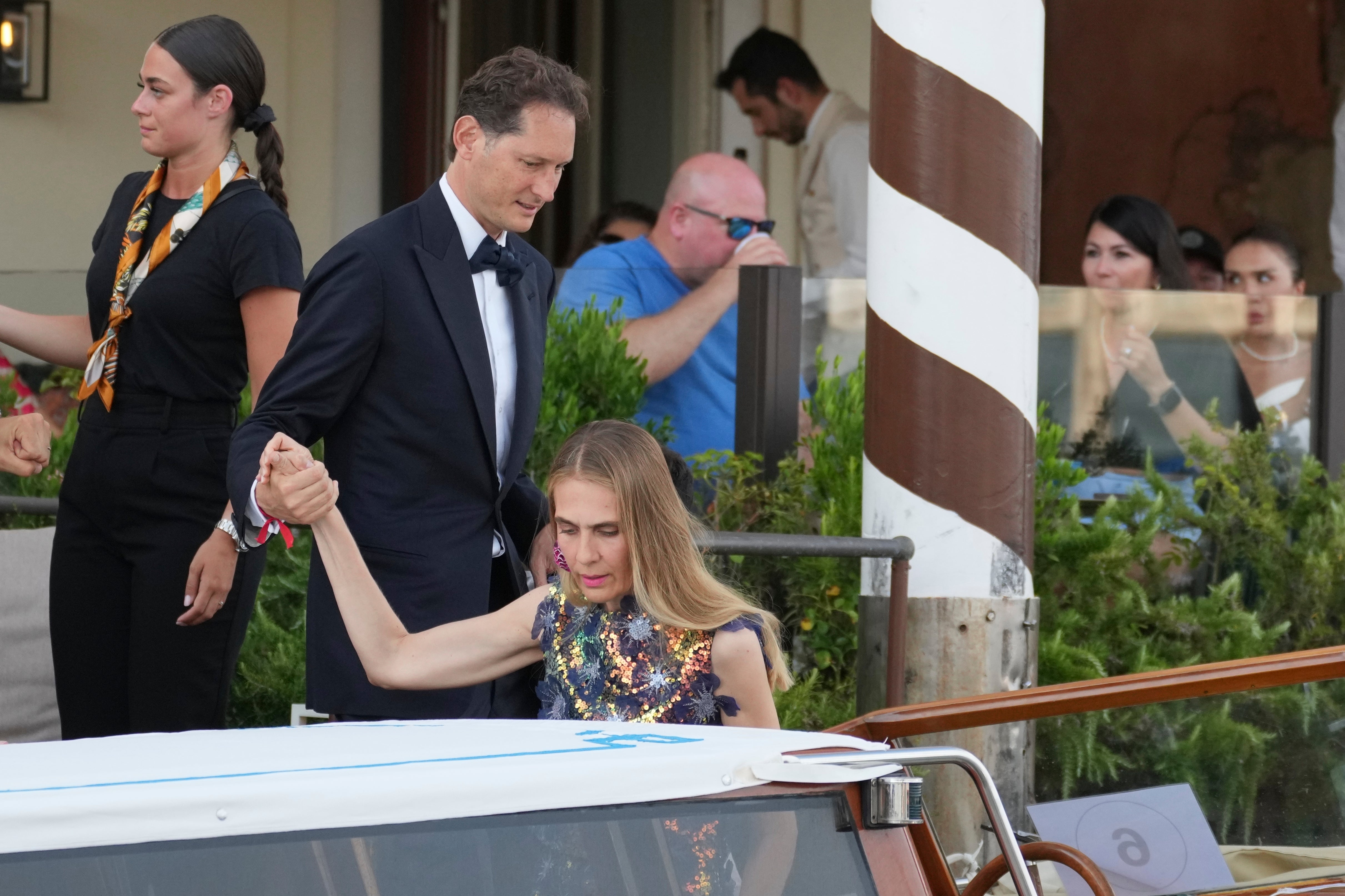 John Elkann, centre left, and Lavinia Borromeo leave a hotel ahead of Jeff Bezos’s wedding in Venice