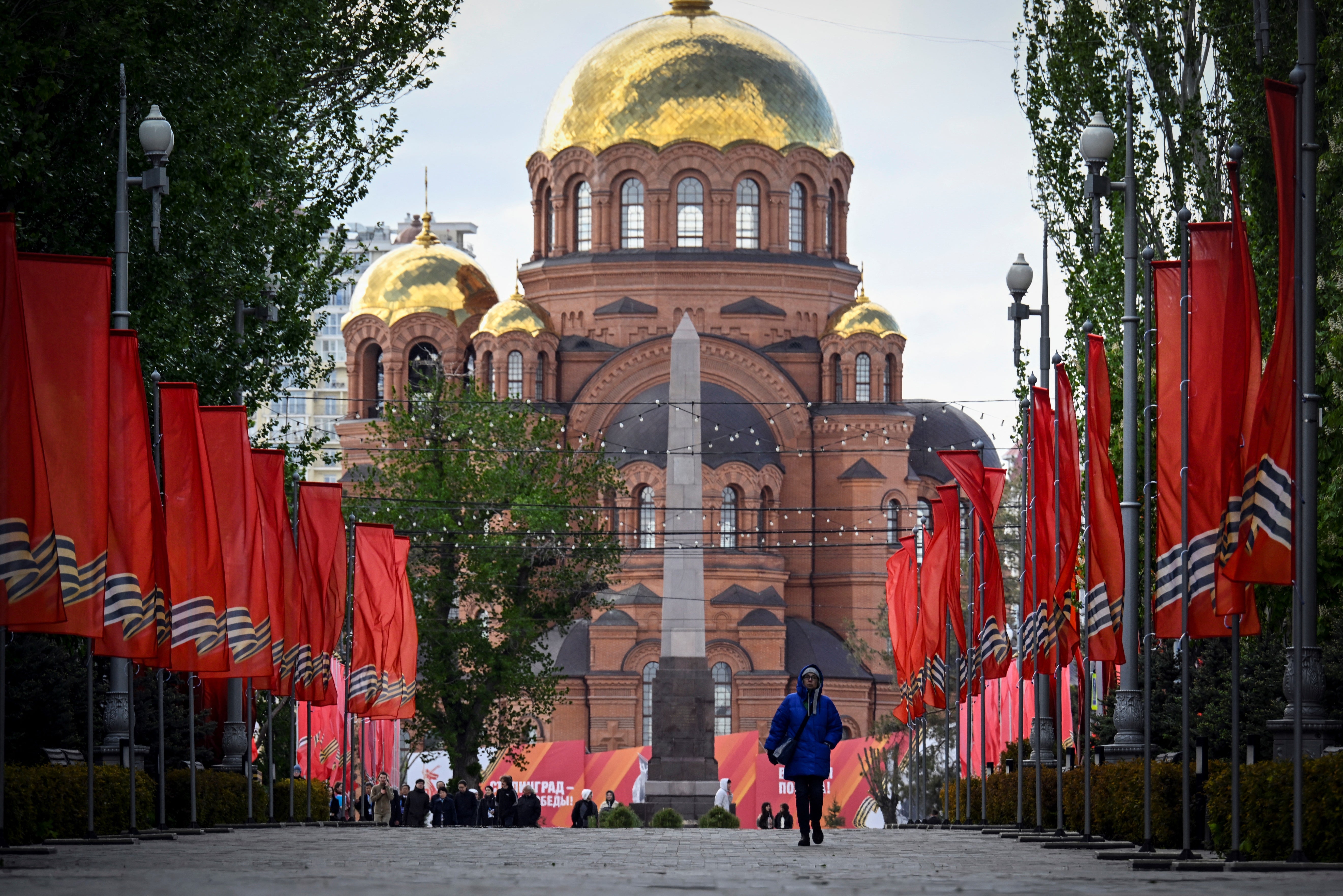 A woman walks past decorations for Russia's Victory Day in central Volgograd