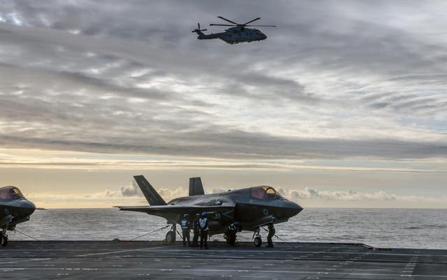 <p>File: Crews prepare a Royal Navy F-35B Lightning fighter jet for take-off from the deck of British aircraft carrier HMS Prince Of Wales in an undisclosed location following its deployment to the Indo-Pacific region</p>