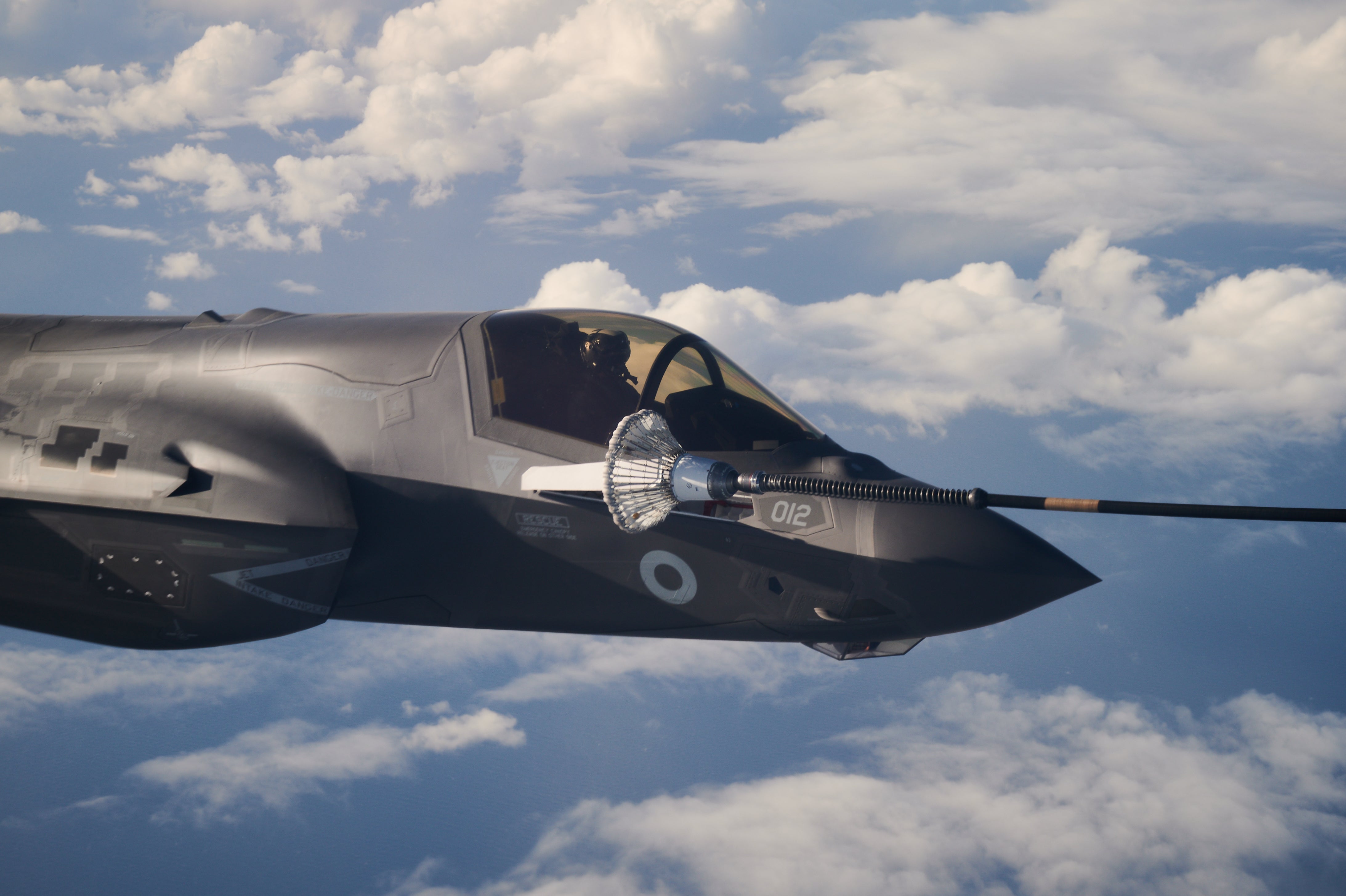 An F-35B combat aircraft from the Royal Air Force refuels from an RAF Voyager aircraft over the North Sea