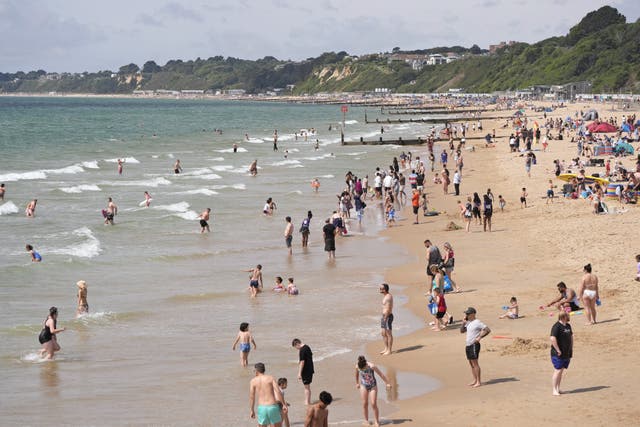 People enjoy the warm weather on Bournemouth Beach in Dorset. (Andrew Matthews/PA)
