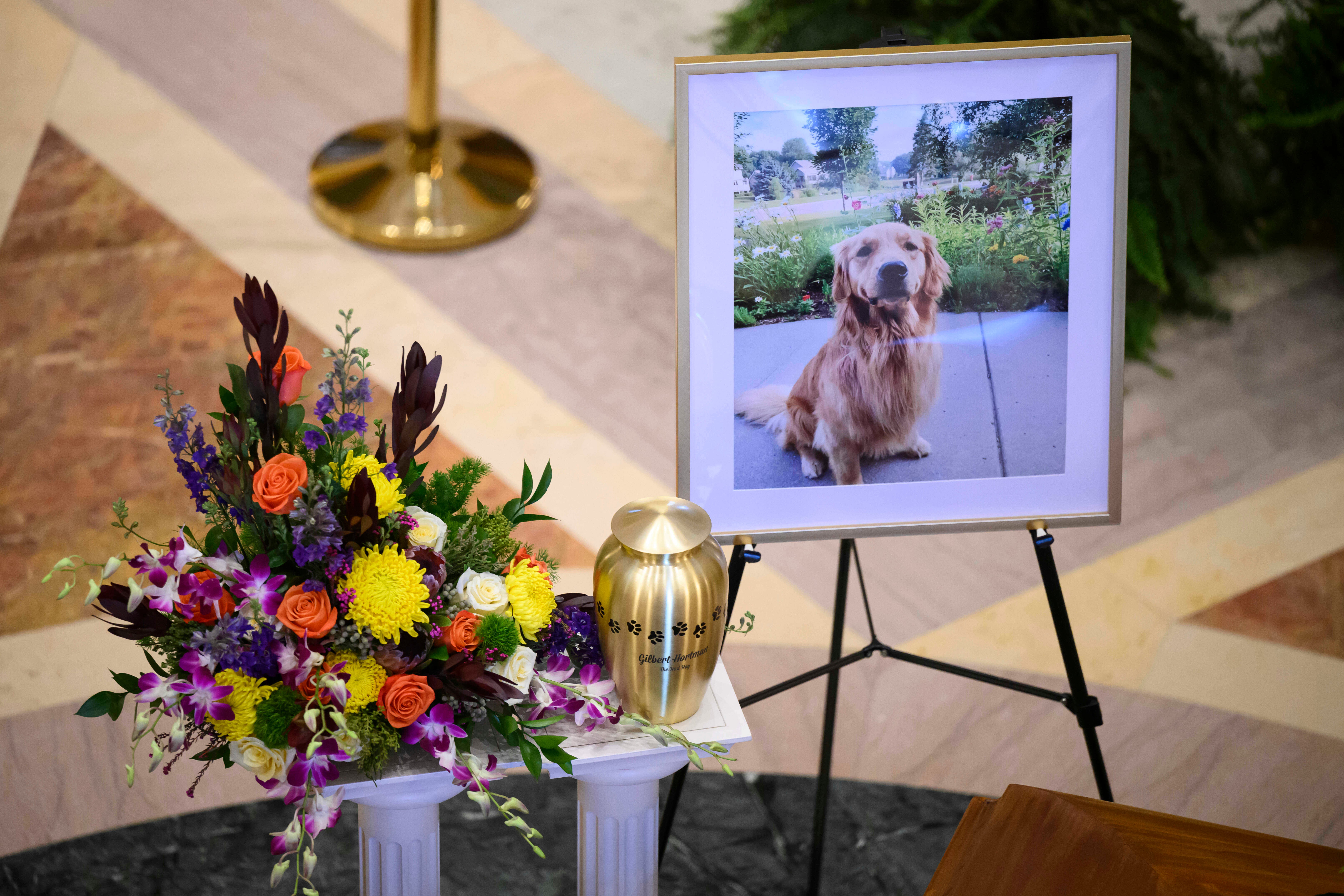 The couple’s beloved dog Gilbert, who died days after the attack from his wounds, was also honored at the service