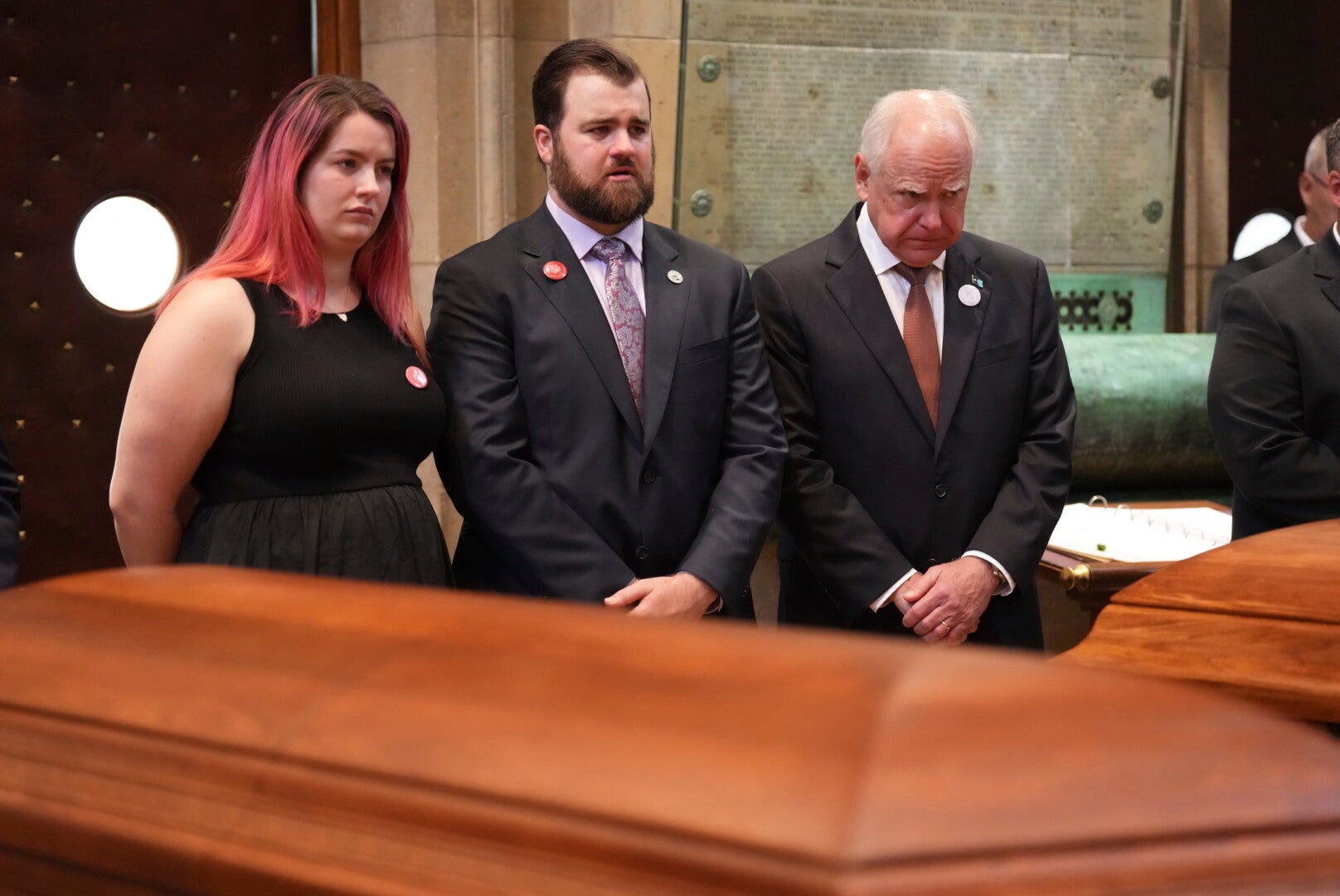 <p>Colin Hortman (center) has called for Donald Trump to take down his post which claimed that Tim Walz (right) was responsible for the shooting of Melissa Hortman and her husband, Mark</p>