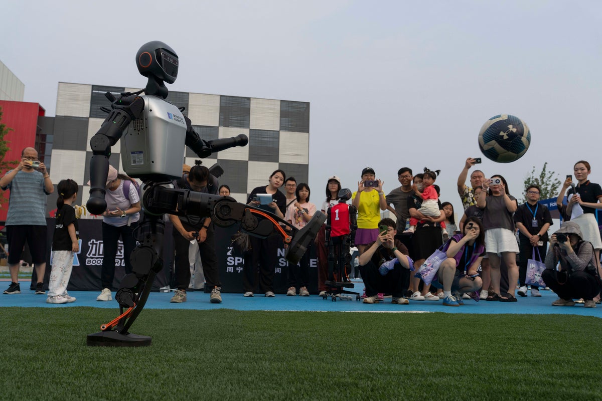 Photos show how humanoid robots captivate fans in China by playing a soccer match