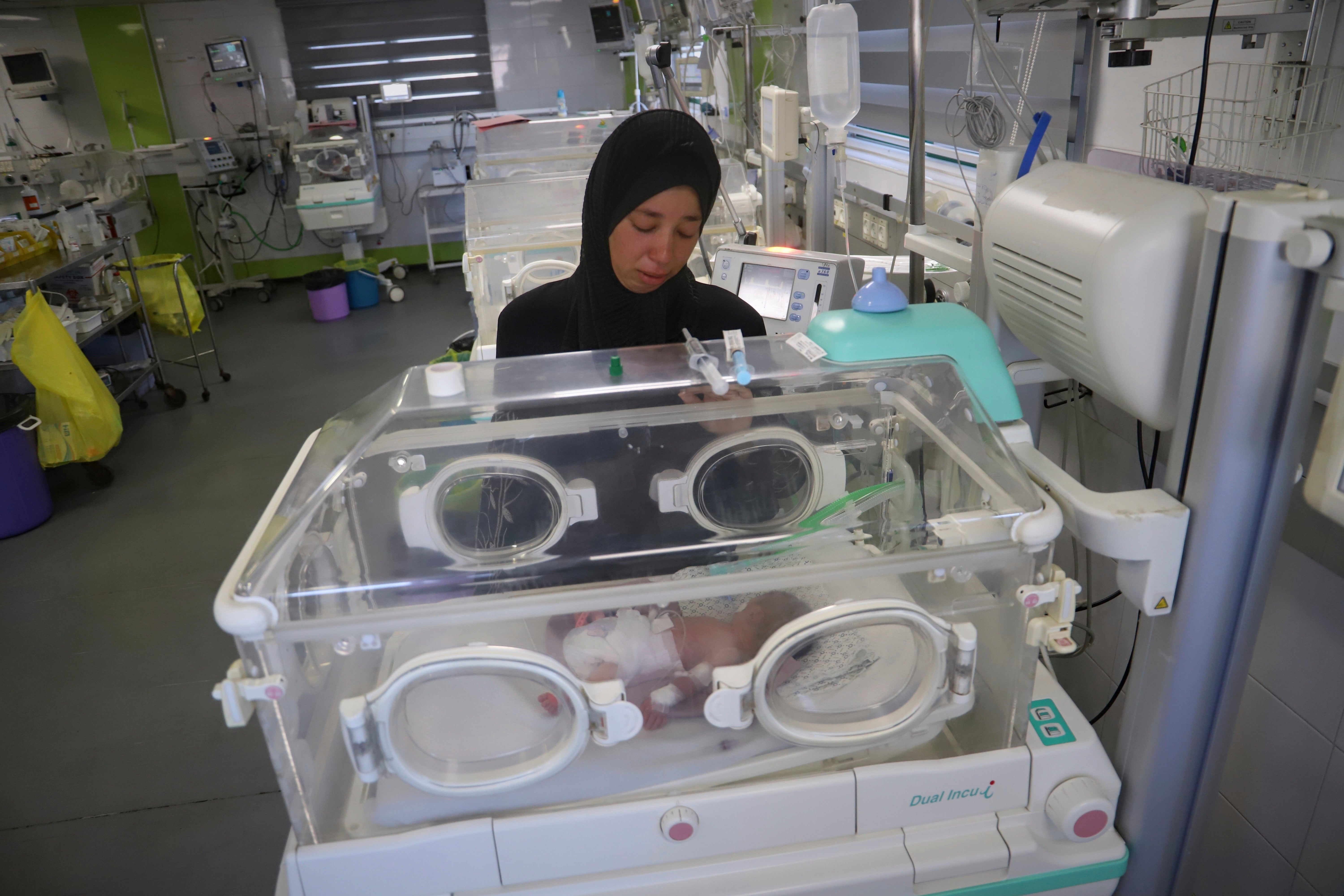 Seham Fawzy Khodeir watches her son, Hisham, born prematurely a few days ago, lying in an incubator at Nasser Hospital in Khan Younis, southern Gaza, on 19 June 2025