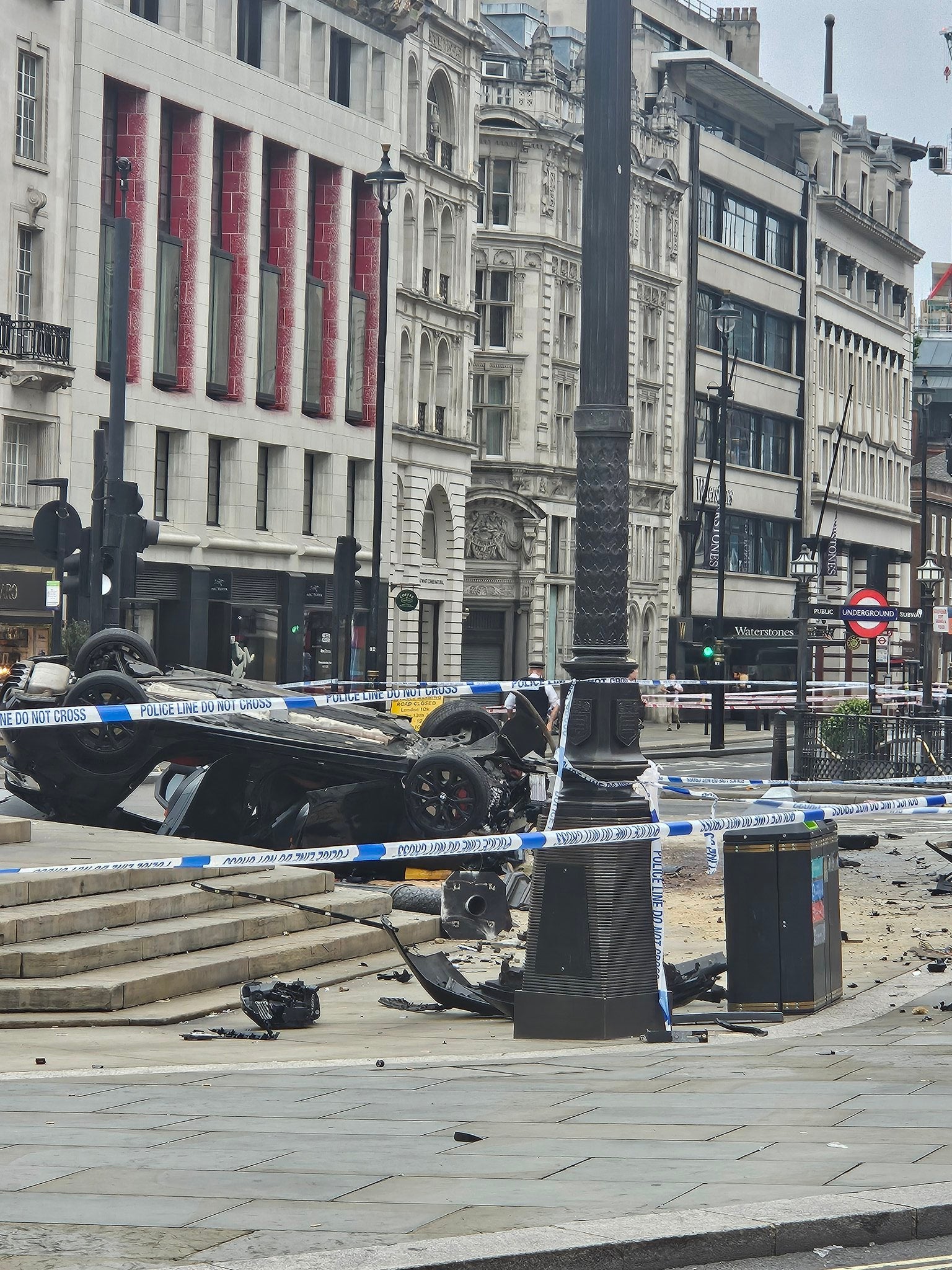 The car was lying on the roof with ruins spread on the ground