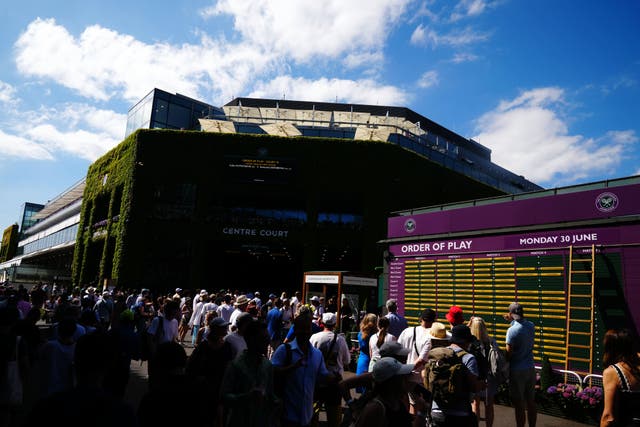 Sunny skies greeted the first fans through the gates at Wimbledon (John Walton/PA)