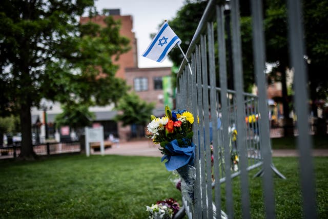 <p>Flowers and a flag at the site of the attack outside the Boulder County Courthouse on June 2 </p>