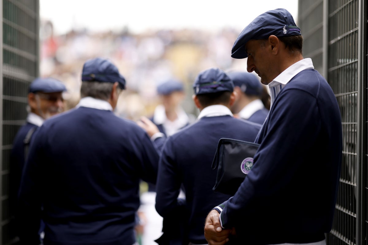 Uniformed protesters criticise introduction of AI line calls at Wimbledon