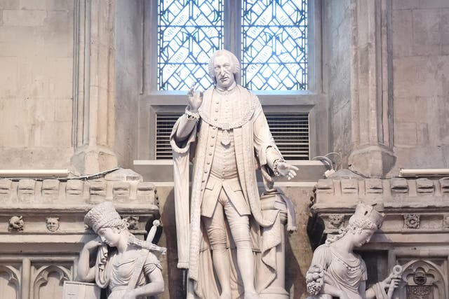 A plaque condemning slave traders is attached to a statue of William Beckford at the Guildhall in London (Stefan Rousseau/PA)