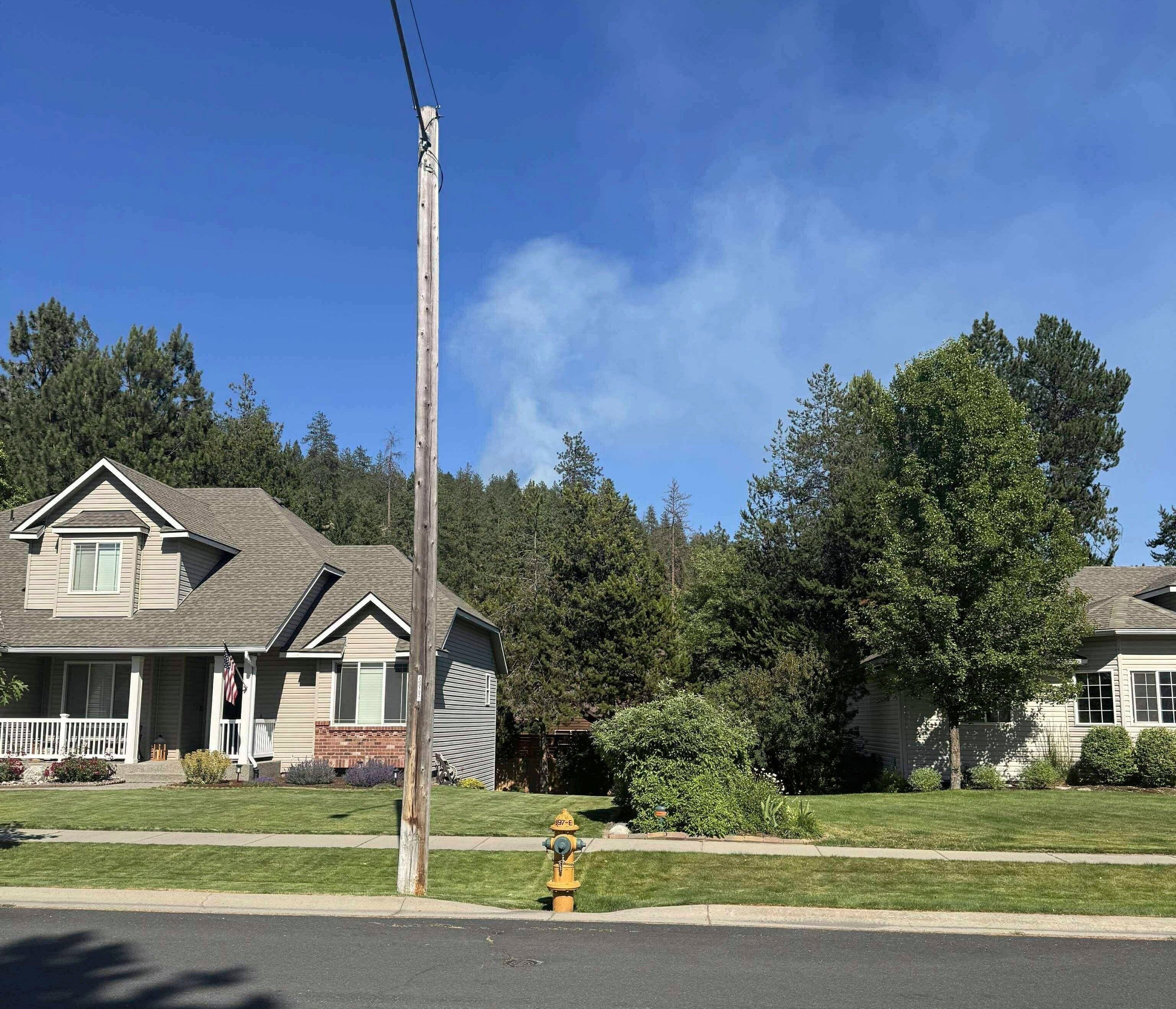 In this photo provided by Mark Lathrop, a blaze burns in a community near Canfield Mountain where a sniper ambushed firefighters responding to the fire, just north of Coeur d'Alene, Idaho, Sunday, 29 June 2025