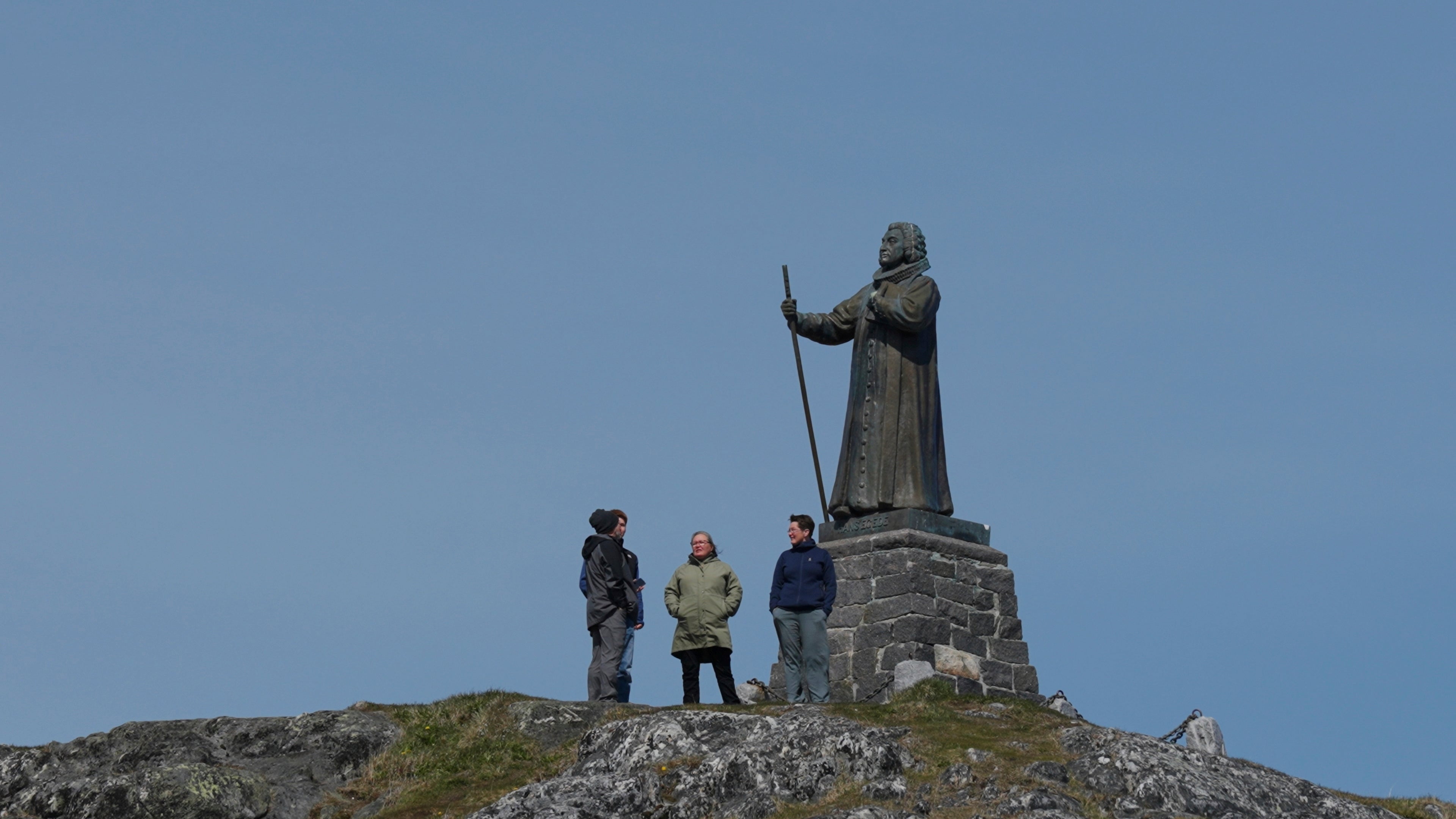 Tourists stand in front of the Statue of Hans Egede in Nuuk, Greenland, Sunday, June 22, 2025. (AP Photo/Kwiyeon Ha)