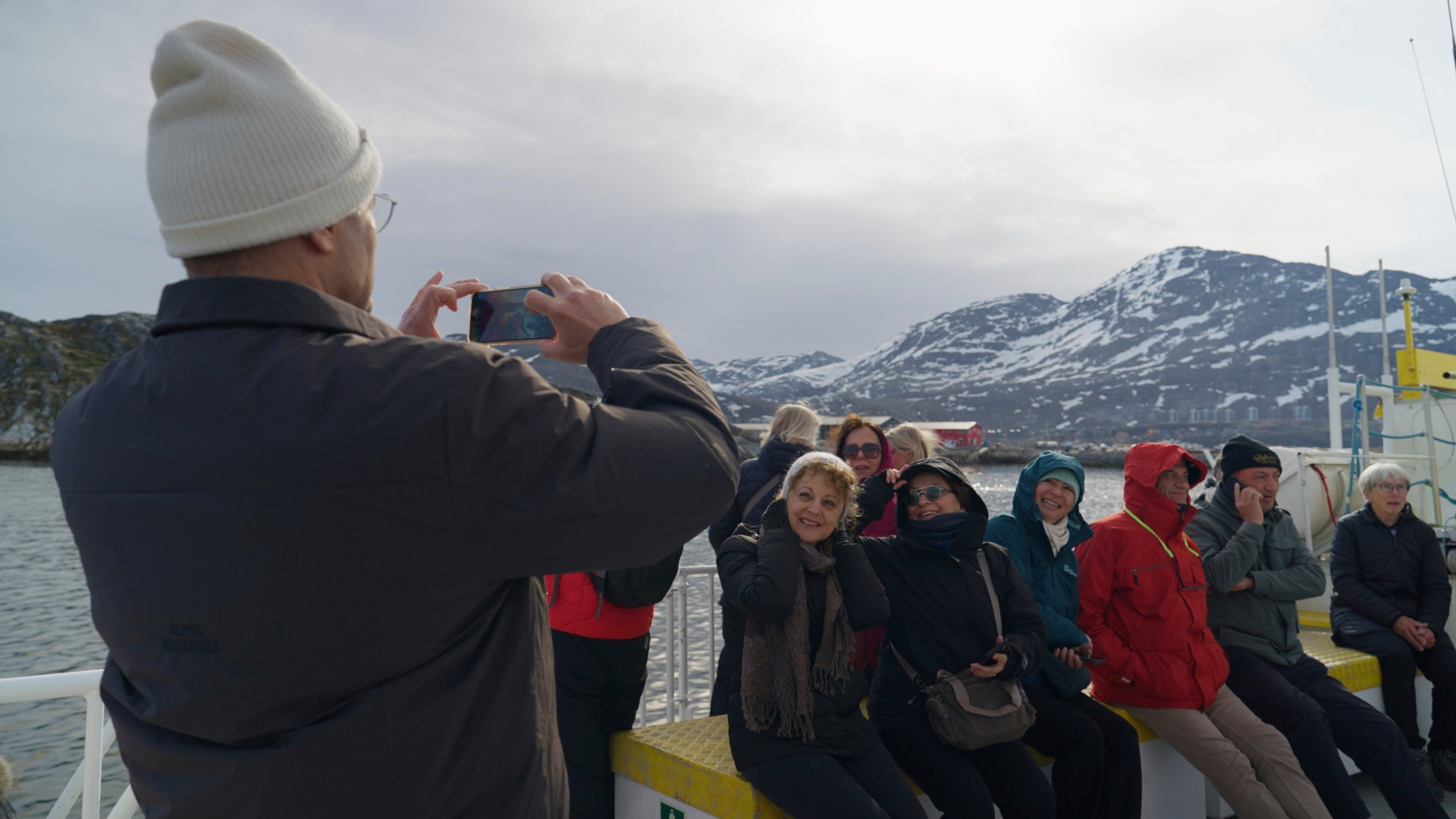 Tourists stand in front of the Statue of Hans Egede in Nuuk, Greenland, Sunday, June 22, 2025. (AP Photo/Kwiyeon Ha)