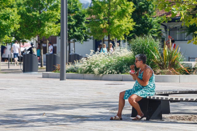 <p>A woman eats an ice cream, Monday, June 30, 2025 in Saint-Jean-de-Luz, southwestern France. (AP Photo/Nicolas Mollo)</p>