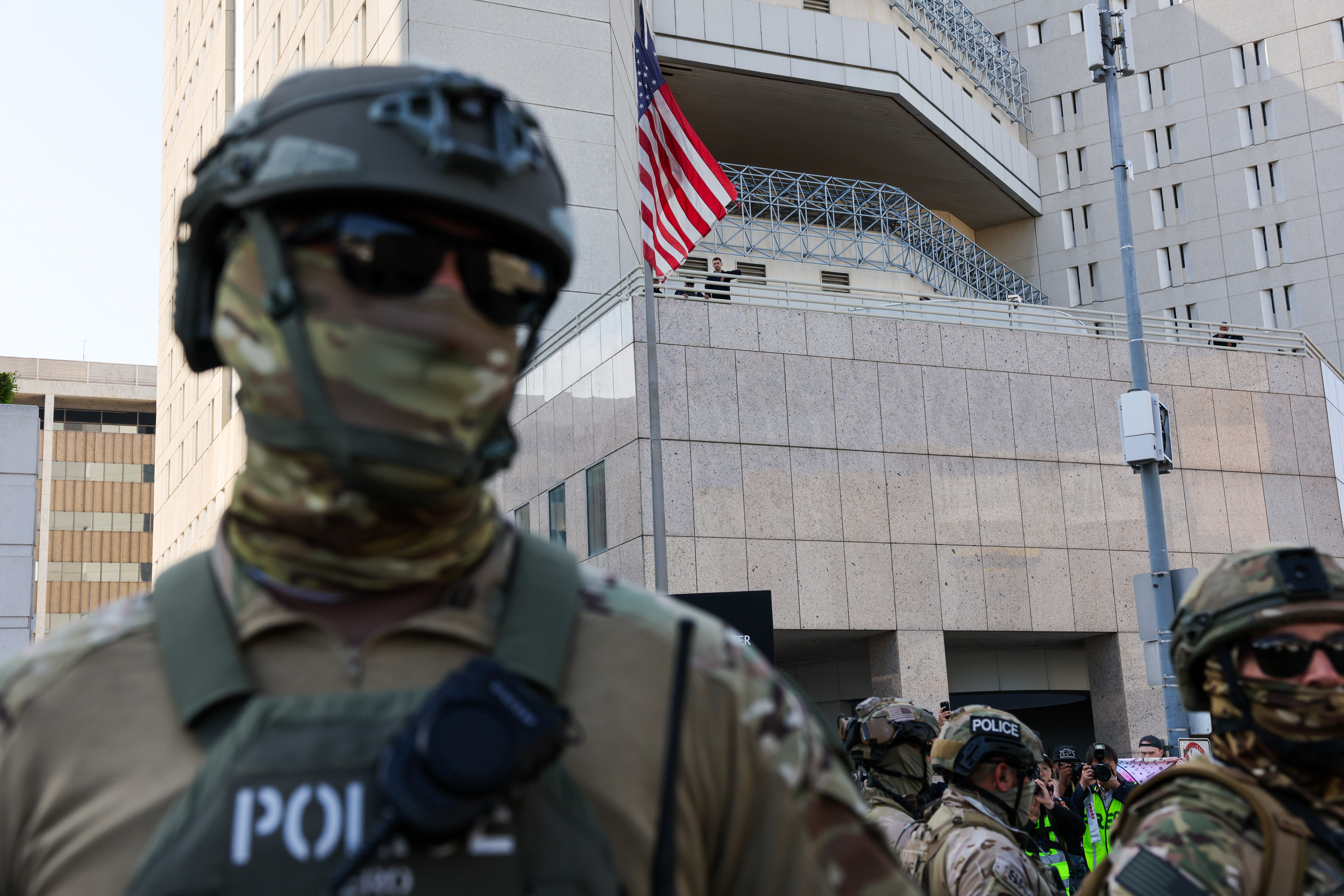 Federal agents guard an ICE detention center in downtown Los Angeles, California