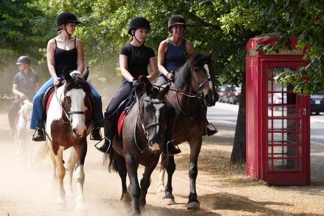 People on horseback in the dry conditions in Hyde Park in London (Jonathan Brady/PA)