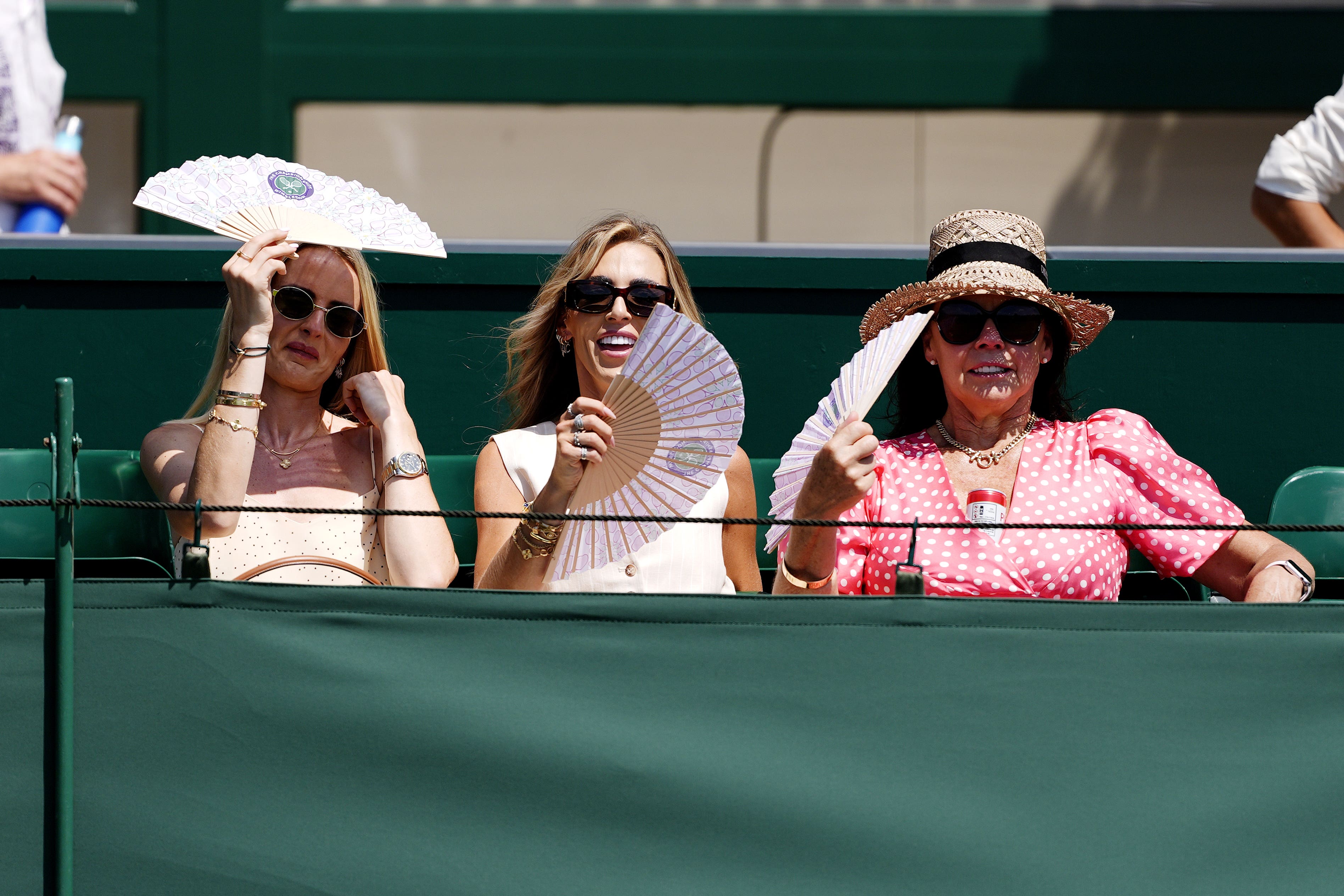 Spectators use fans to cool down (PA)