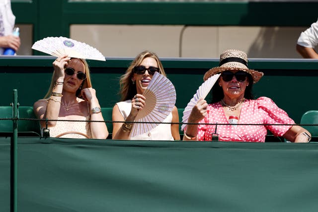 Spectators use fans to cool down (PA)