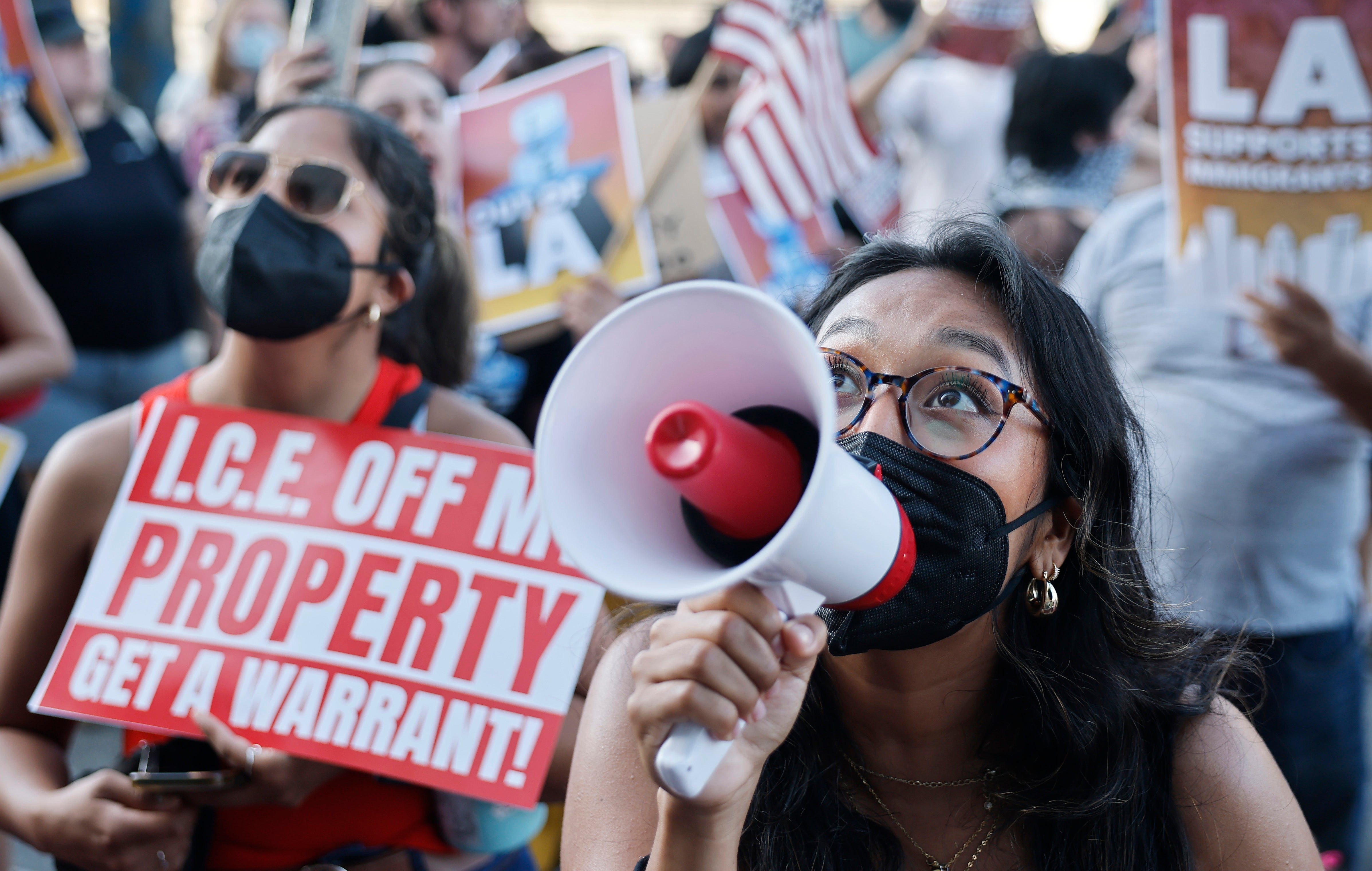 Demonstrators call out toward ICE detainees held inside Metropolitan Detention Center in Los Angeles, California, where thousands of people joined protests targeting raids and immigration arrests