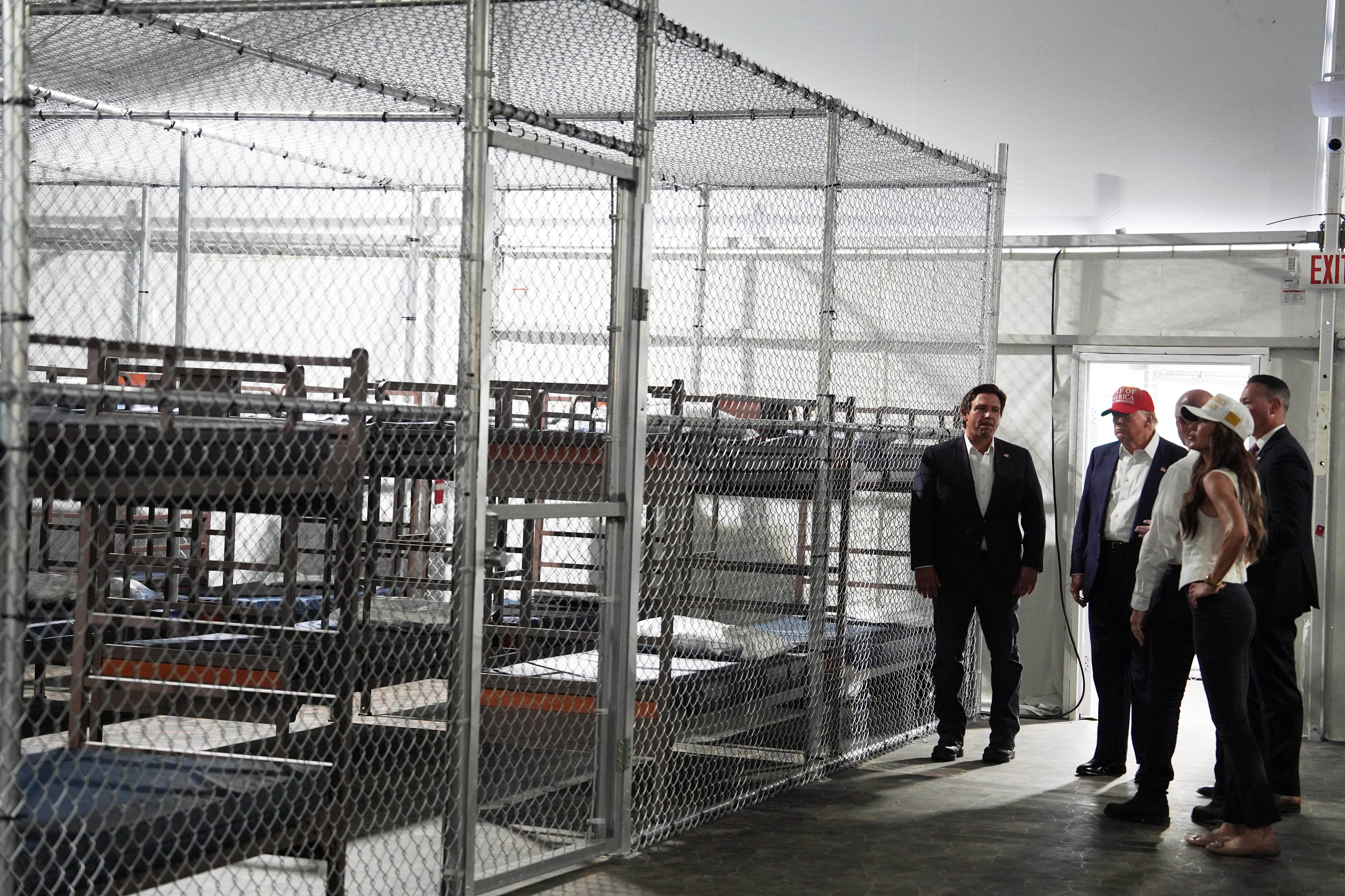 The first detainees arrived Thursday at the facility, which will cost $450 million to operate and consists of tents and trailers surrounded by razor wire on swampland about 45 miles west of downtown Miami