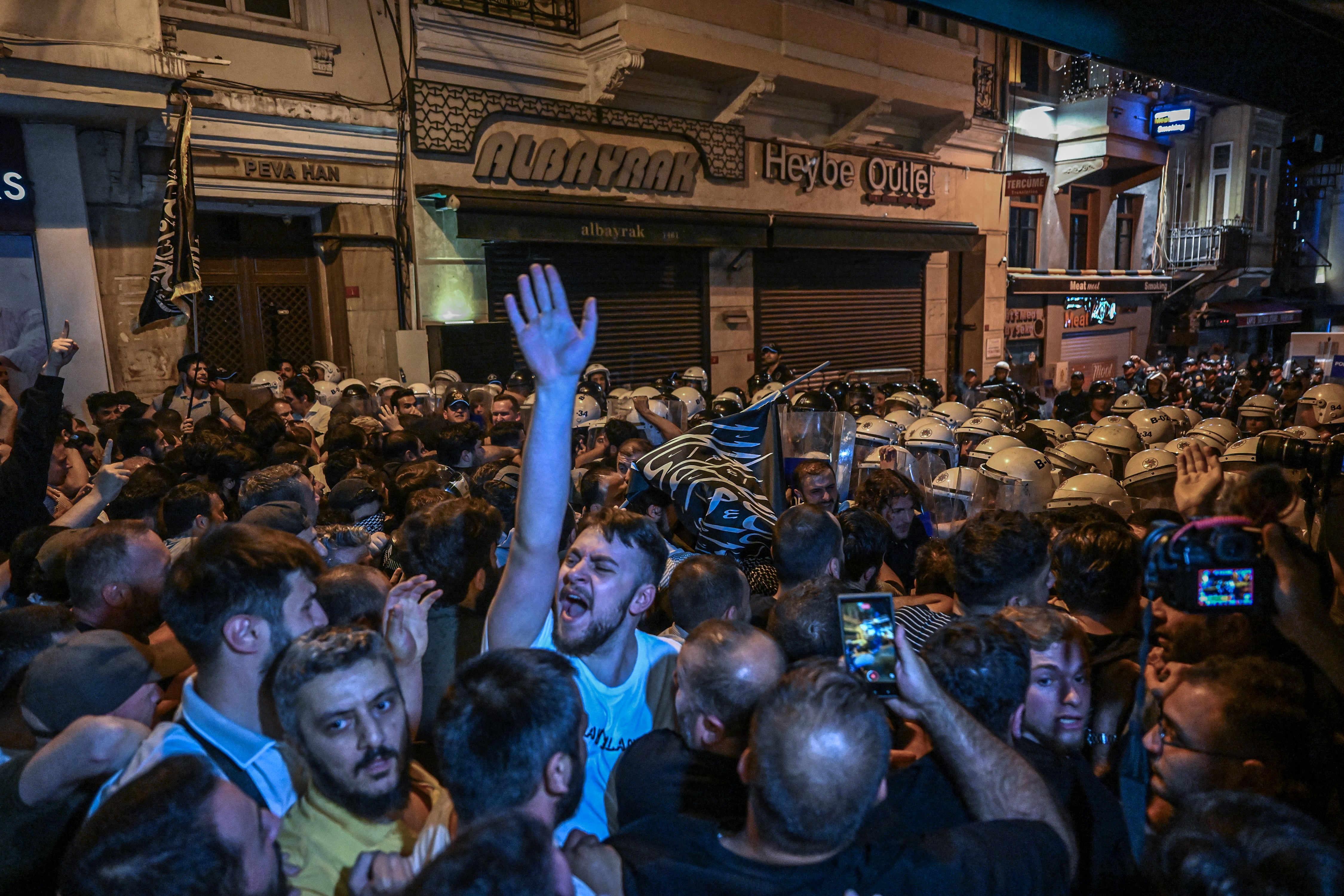 Islamist protesters clash with Turkish anti-riot police officers as they gather to protest LeMan magazine in Istanbul on 30 June 2025. Clashes erupted in Istanbul on Monday with police firing rubber bullets and tear gas to break up an angry mob after allegations that a satirical magazine had published a cartoon of the Prophet Mohammed