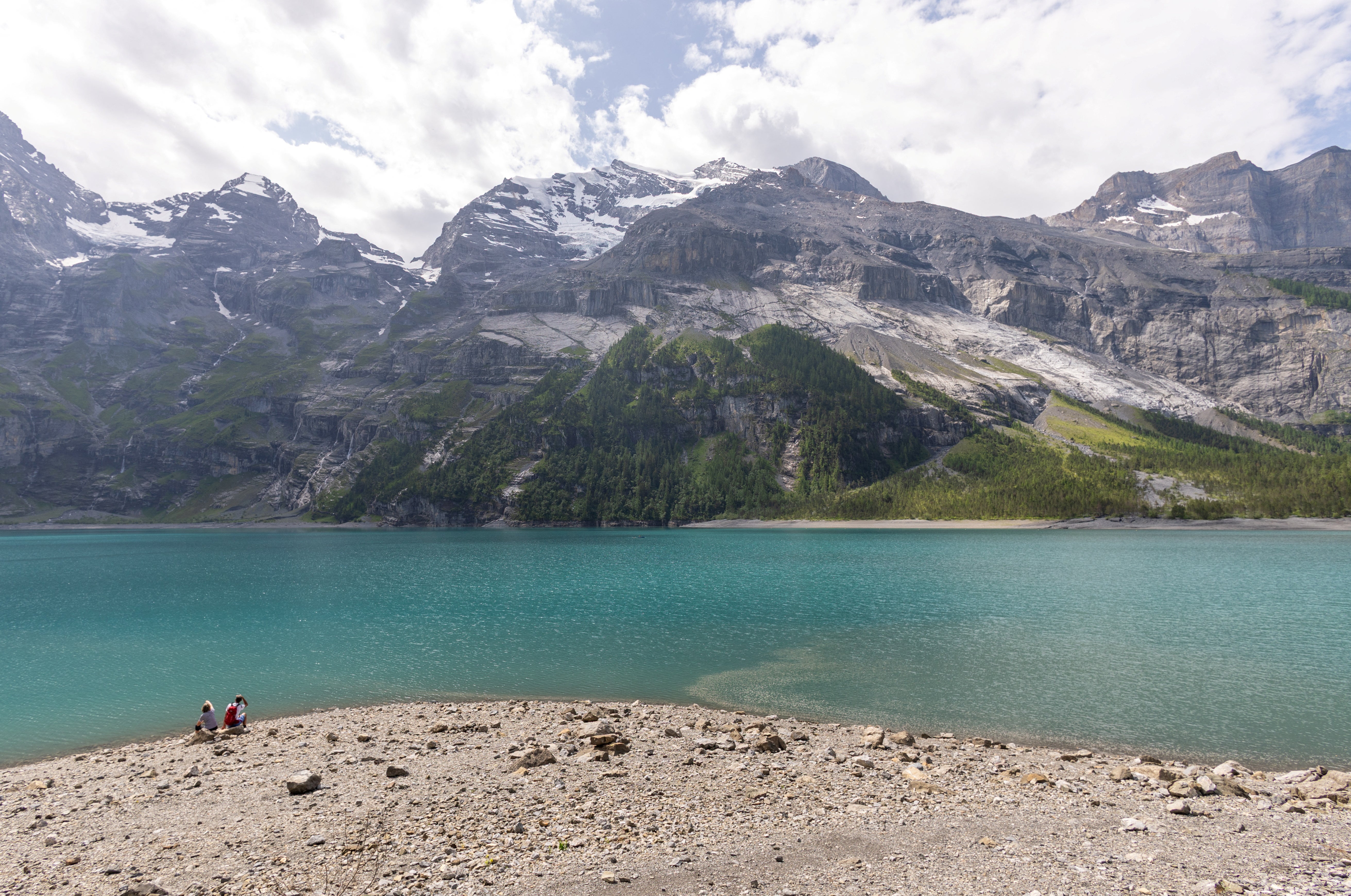 Hikers look a the Spitzen Stein at the Oeschinensee, as flash floods and rock falls threaten the village amid climate change and warming permafrost pose increasing challenges in Kandersteg, Switzerland, June 26, 2025. REUTERS/Denis Balibouse
