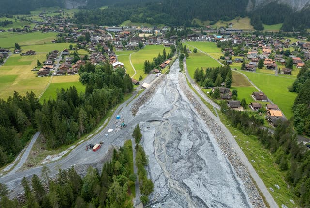 <p>A drone view shows the Oeschiwand (Oeschi Wall) in the Oeschibach River, protecting the village from flash floods and rock falls from Spitzen Stein at Oeschinensee, as climate change and warming permafrost pose increasing challenges in Kandersteg, Switzerland, June 26, 2025</p>