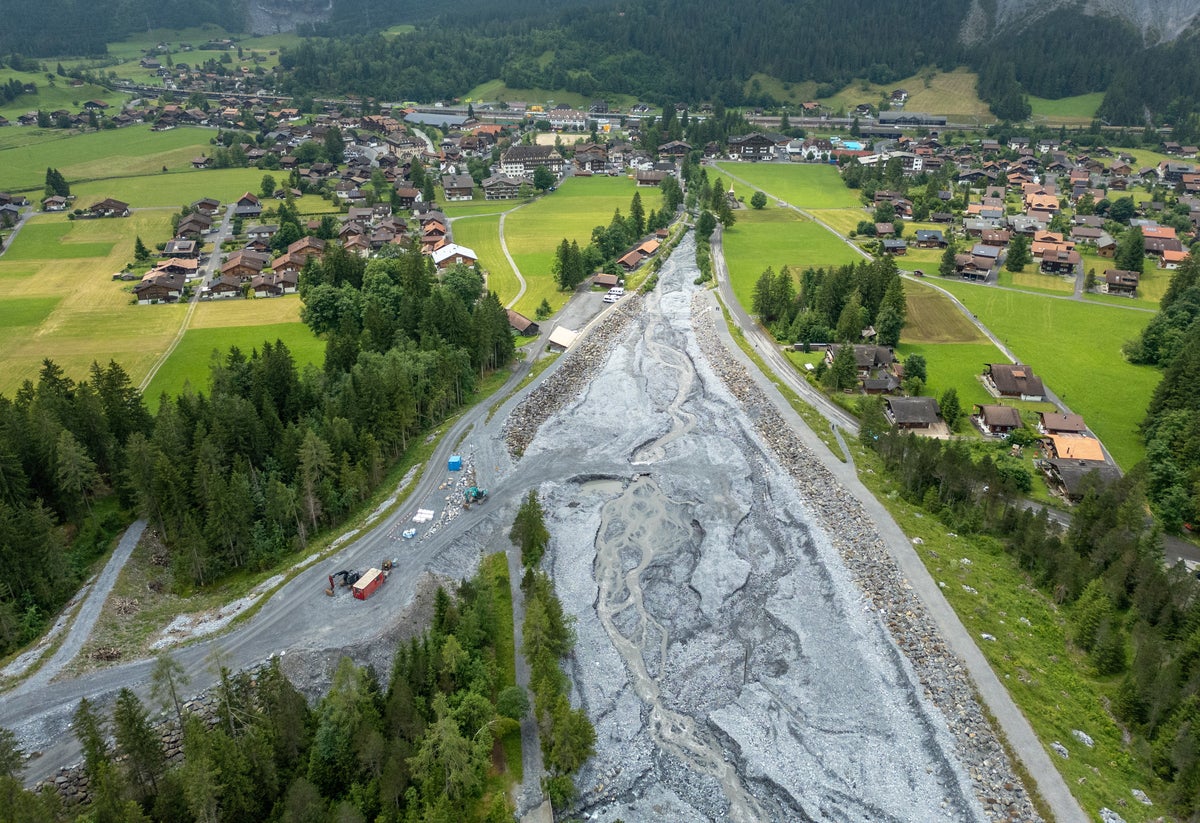 Villagers nervously watch a mountain peak after rockslide buried their neighbours