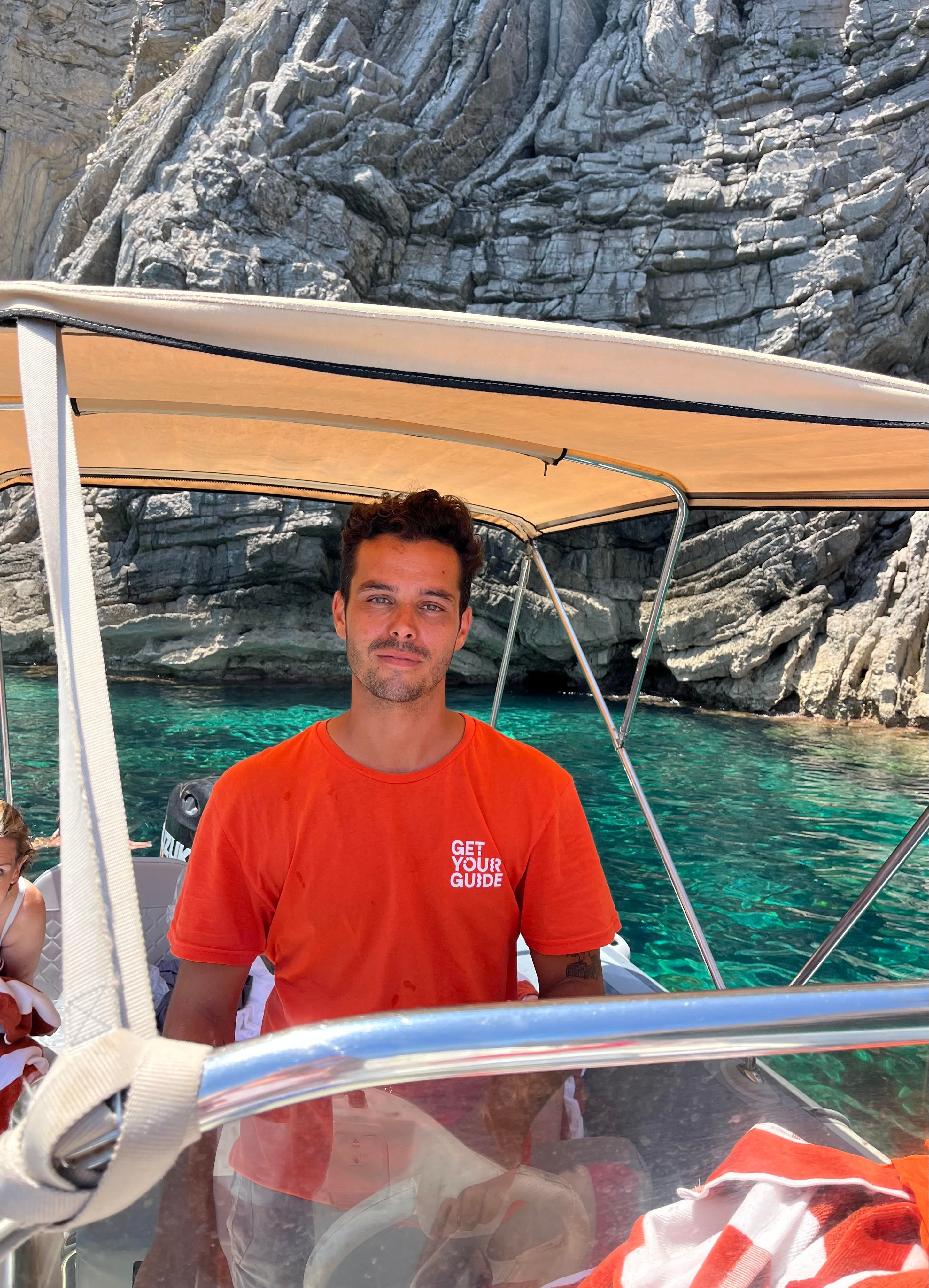 Pablo, the GetYourGuide tour guide, at the helm of the boat in Ibiza (Camilla Foster/PA)