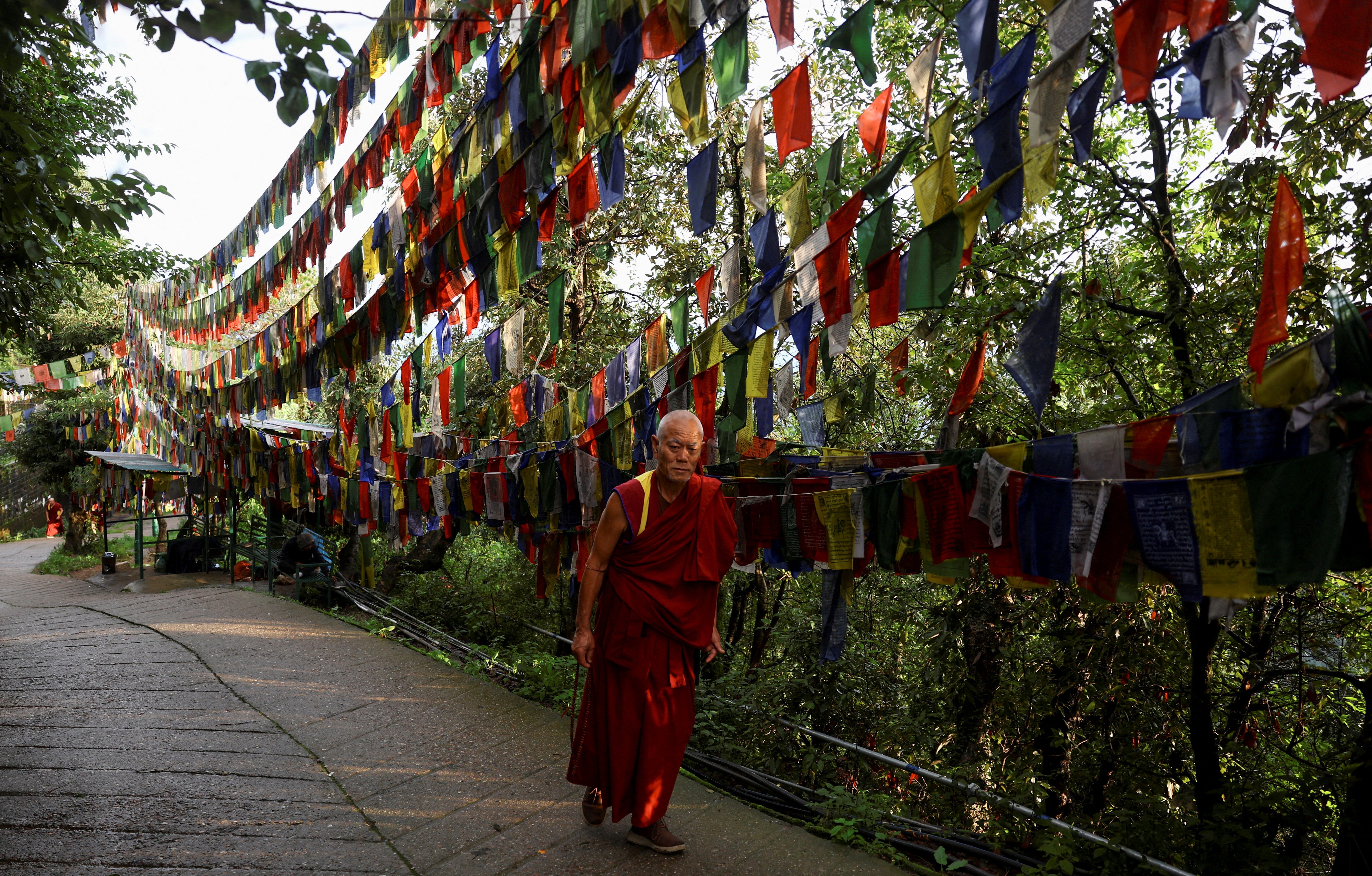 A Tibetan monk circumambulates clockwise around Tsuglagkhang, also known as Dalai Lama's Temple complex