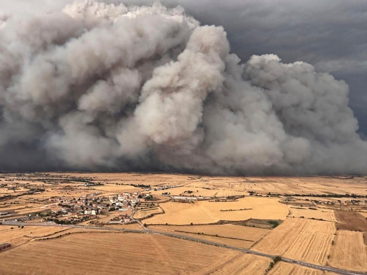 In this photo released by Agents Rurals de Catalunya, uncontrolled fire rages across the grasslands in the Segarra region, in the rural province of Lleida, Spain, on Tuesday