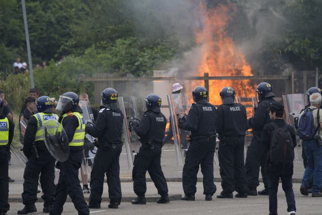 Police officers with protesters as trouble flared during an anti-immigration demonstration outside a hotel in Rotherham, South Yorkshire (PA)
