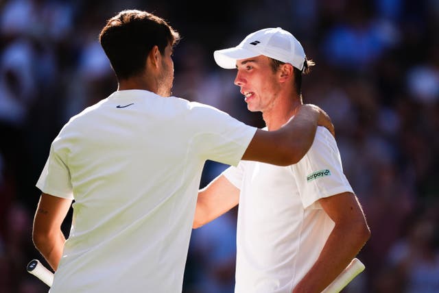 <p>Carlos Alcaraz, left, congratulates Ollie Tarvet on his run to the second round of Wimbledon</p>