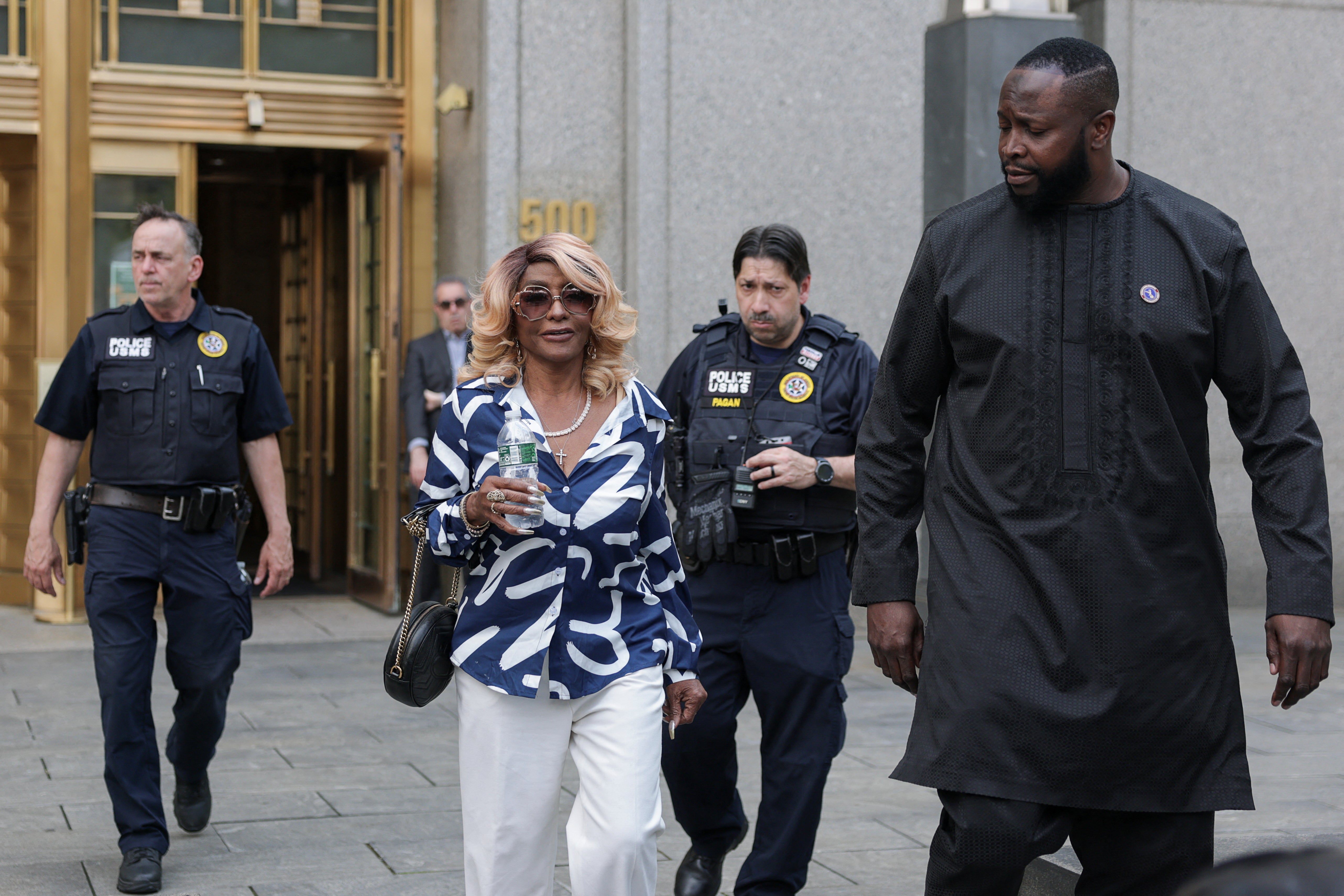 Janice Combs walks outside the U.S. federal court, after the jury reached verdicts in the Sean 