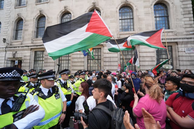 <p>Police and protesters face off in a pro-Palestine demonstration last month (Lucy North/PA)</p>
