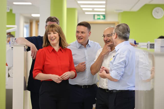 Rachel Reeves was smiling alongside Wes Streeting, centre, and Sir Keir Starmer, right (Jack Hill/The Times)