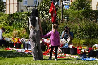 People gather to leave tributes at Anfield Stadium, home of Liverpool, in memory of Diogo Jota who has died at the age of 28