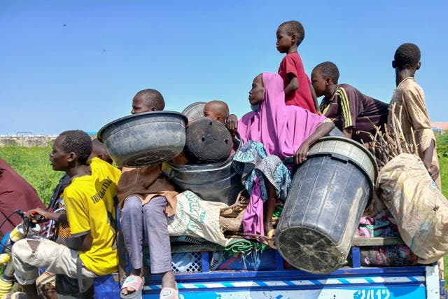 <p>Residents carry their salvaged belongings on a motorcycle in Maiduguri, the capital of Borno State in the Lake Chad region of Nigeria </p>
