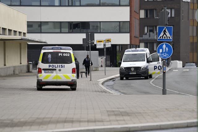 <p>Police vehicles are seen outside the Ratina shopping centre in Tampere</p>