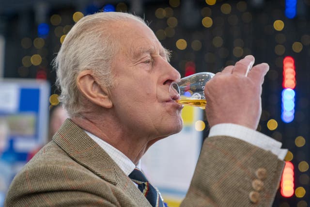 The King drinks a glass of whisky (Jane Barlow/PA)