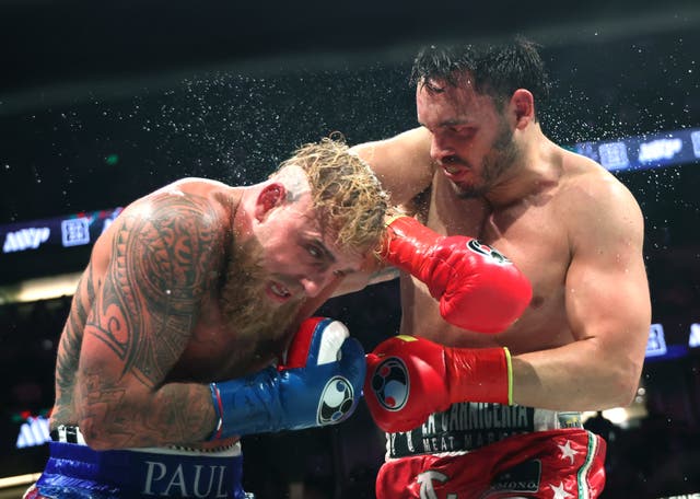 <p>Julio Cesar Chavez Jr. (right) fights Jake Paul in Anaheim, California on Saturday. The Department of Homeland Security says Chavez has since been arrested and is set to be deported</p>