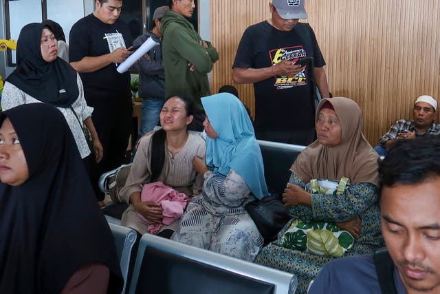 <p>A passenger's relative weeps after a ferry carrying dozens of passengers sank near the resort island of Bali</p>