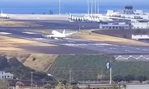 Plane bounces off runway while battling strong winds at airport