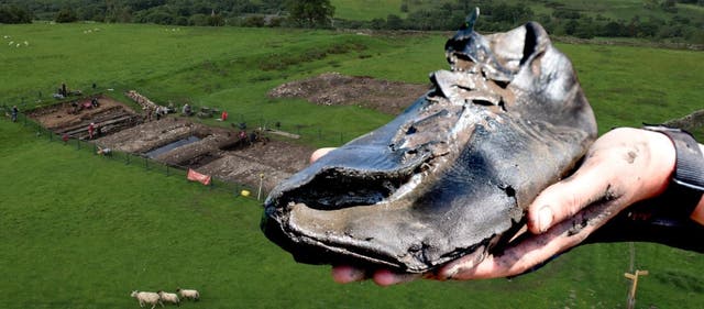 <p>Eight leather shoes, each at least 30cm long, were discovered in a defensive ditch</p>